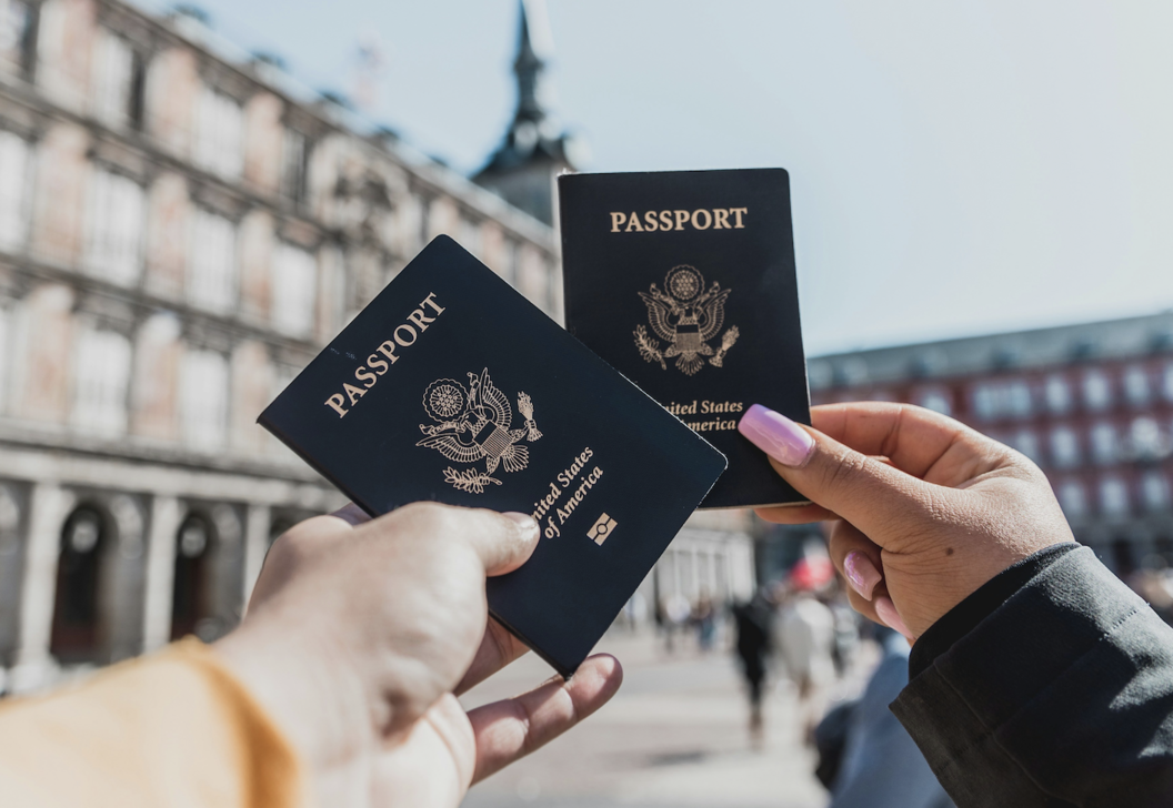 Two people holding passports in their hands
